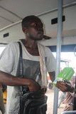 Man selling herbal medicine on a passenger